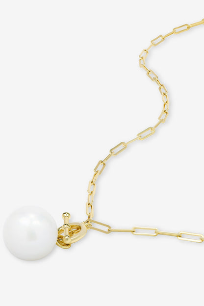 A gold paperclip chain necklace featuring a single XL white pearl pendant, shown on a clean white background.