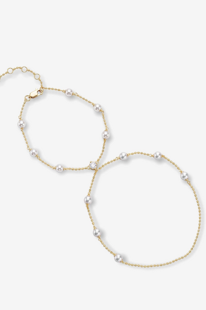 Gold pearl hand chain on a white background 