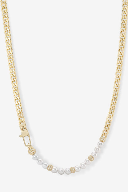 A gold chain necklace featuring a curved section of white pearls separated by small gold spacer beads, displayed on a light gray background.