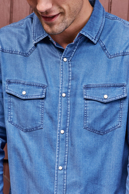 Close up of man wearing Sacramento Longsleeve Chambray Western Shirt in Medium Wash