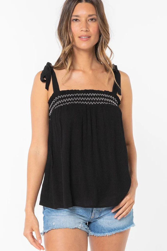 Black smocked tank top with zigzag trim and tie bow shoulder straps, front view