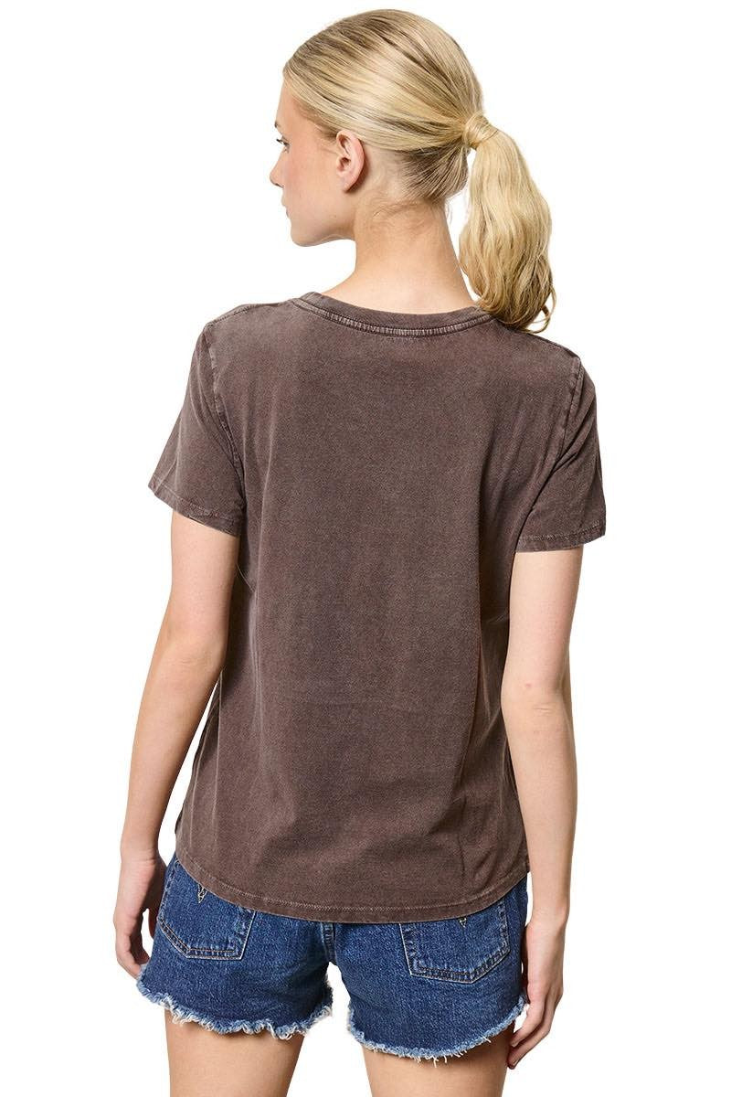 Woman wearing a brown t-shirt and denim shorts on a white background