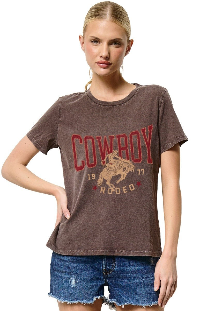 Woman wearing a brown t-shirt with 'Cowboy Rodeo' graphic design on a white background