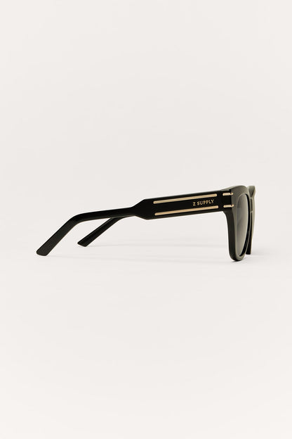 Front row sunglasses in polished black with gold detail and Z Supply logo show from the side 