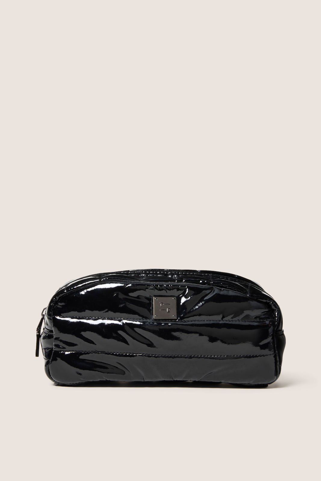 Black patent leather pouch on a beige background