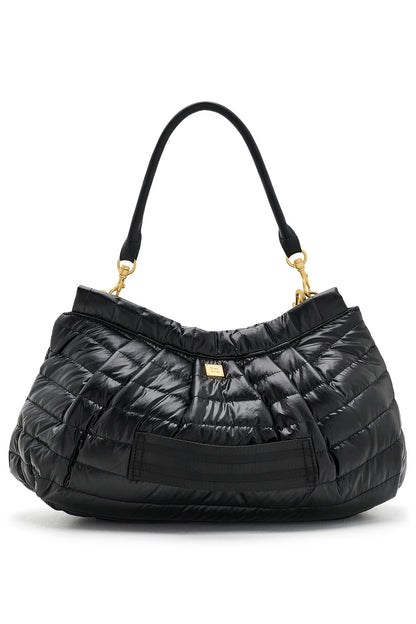 A hold me close clutch black quilted puffer handbag with a single shoulder strap and gold-tone hardware, shown against a plain white background.