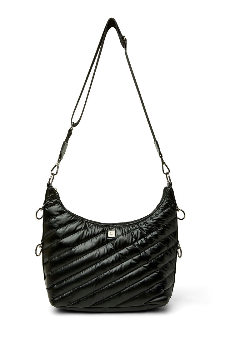 An ICON black quilted crescent-shaped shoulder bag with diagonal stitching, a thin black shoulder strap, and silver-tone hardware, shown against a plain white background.