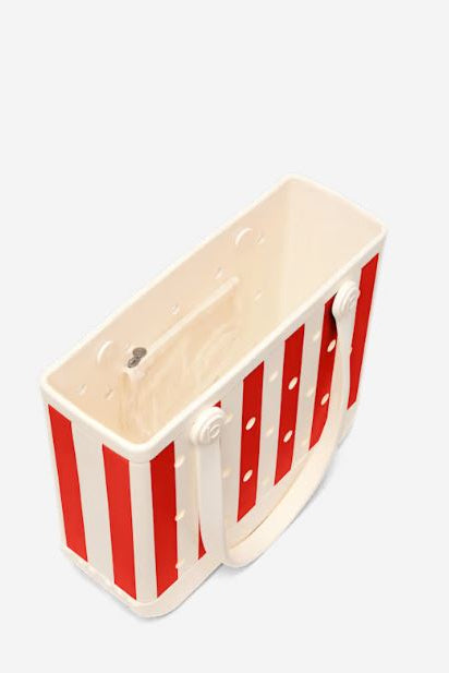 A Bogg brand tote bag featuring a red and white vertical stripe pattern with inside completely white, and inner pocket