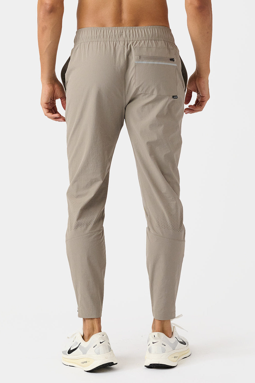 Taupe Carson jogger pants worn by a person on a white background