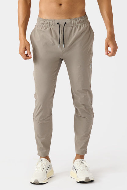 Carson Taupe jogger pants worn by a person on a white background