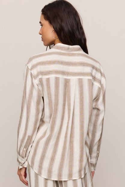 Back view of woman wearing a light toffee striped button up top and matching pants 