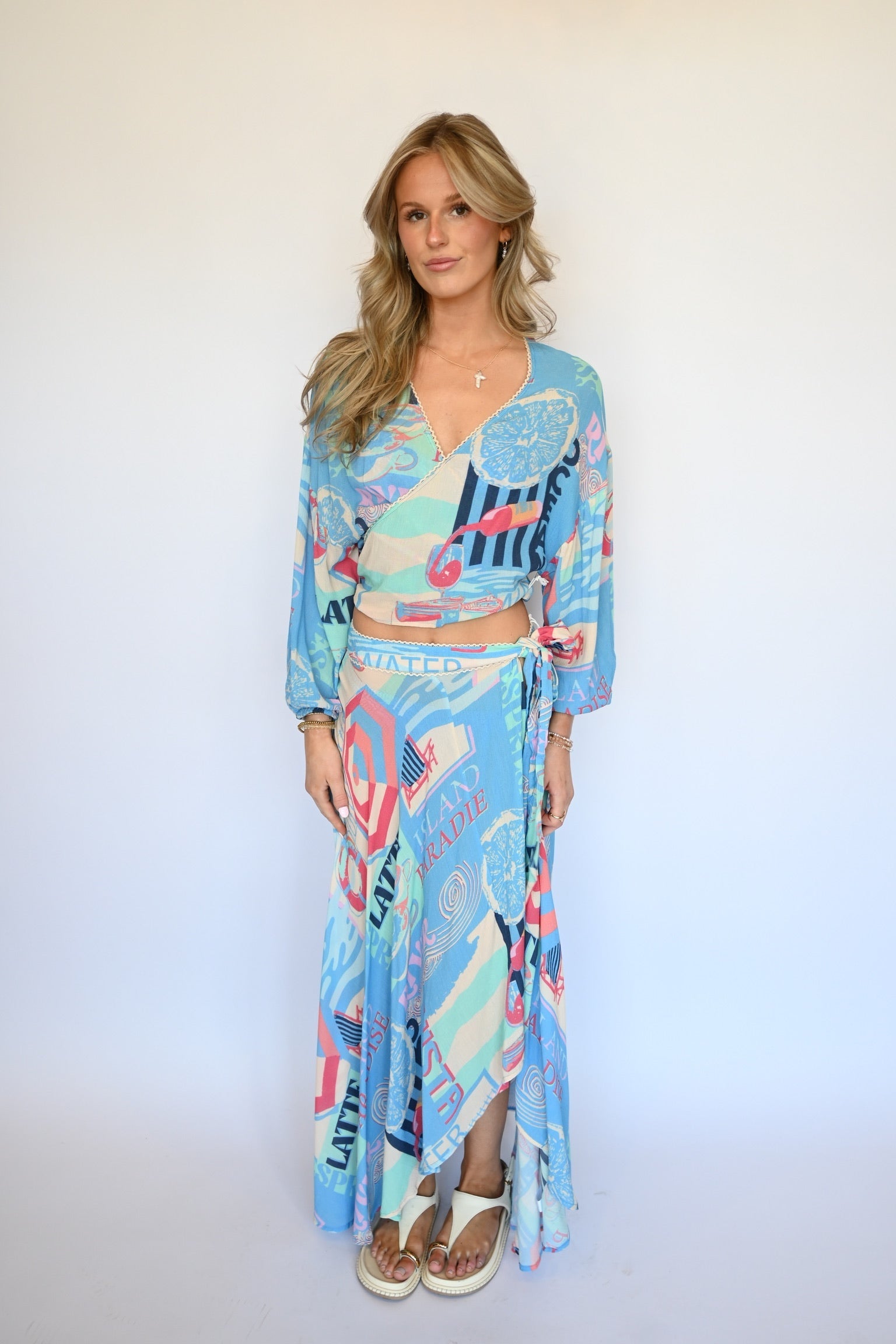 Woman wearing a colorful outfit with abstract bluye vacay pattern on a white background