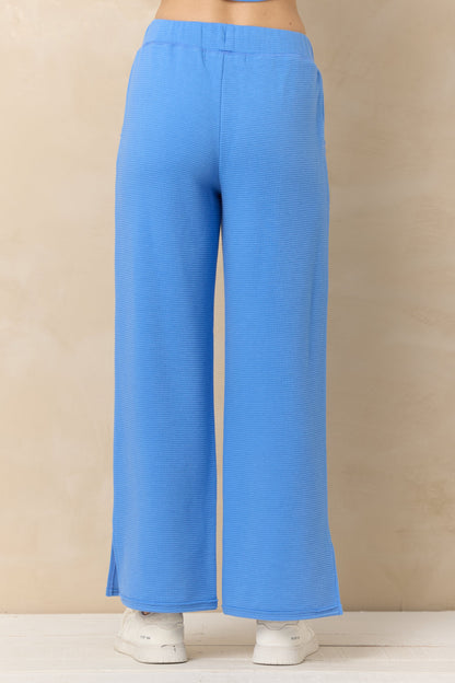 Back view of marine Blue pants on a beige background
