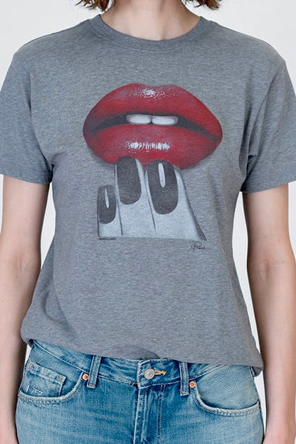 A person wearing a heather gray graphic t-shirt featuring a red lips and manicure design, paired with blue jeans, against a plain light gray background.