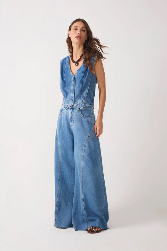 Front view of woman wearing a denim top and denim pockets belt loops flared pants 