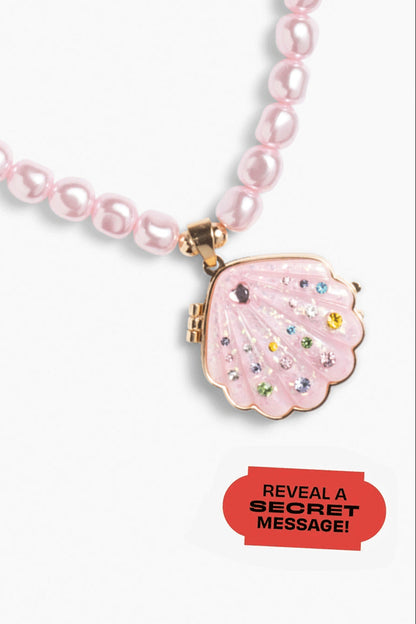 Pink beaded necklace with a clasp that reveals a secret message on a white background