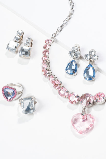 'Big Pres' jewelry set with pink and blue crystals on a white background