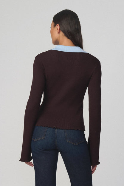 Back view of woman wearing the riley polo sweater in espresso with a light blue collar and dark blue jeans 
