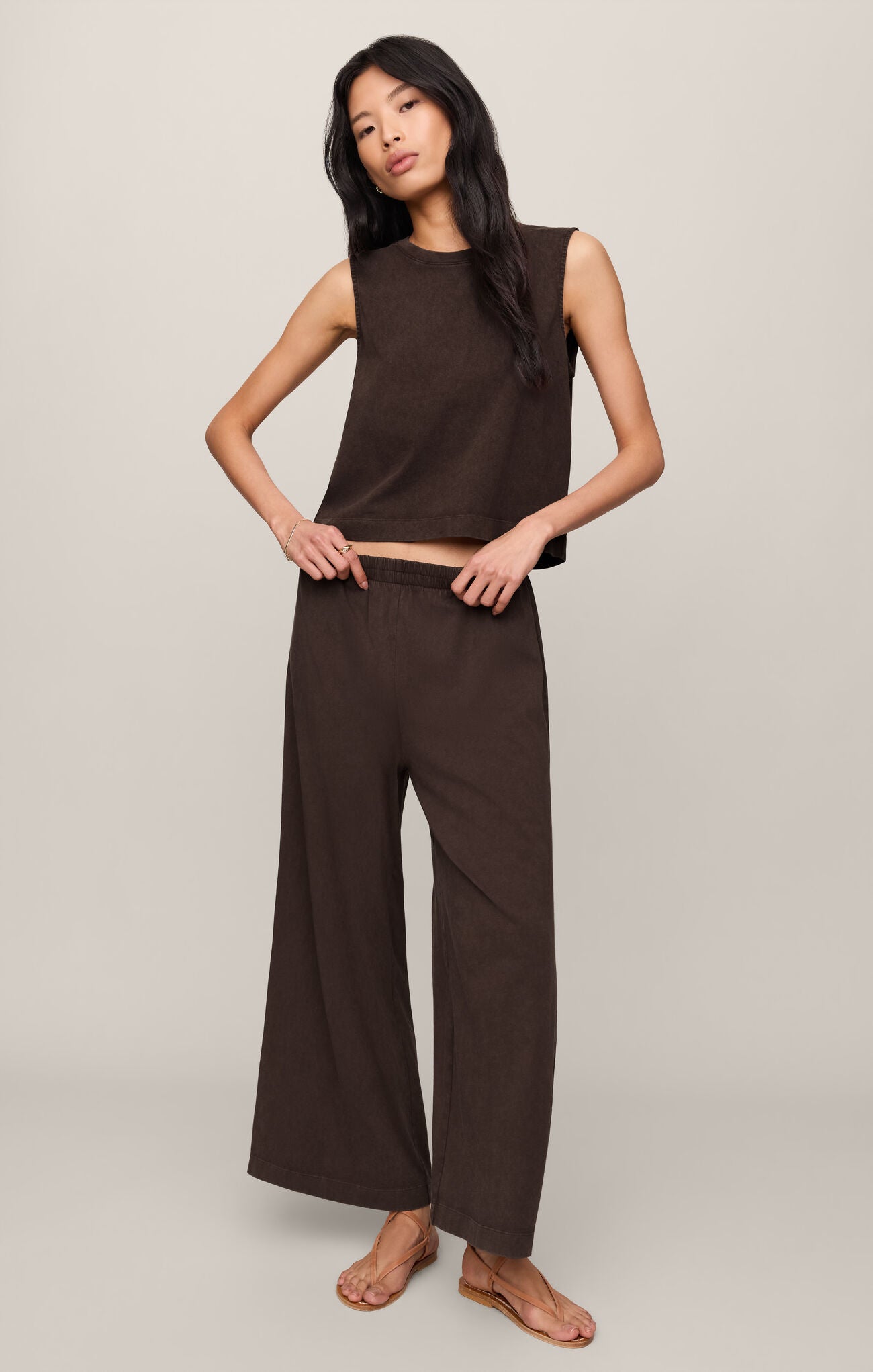 Woman wearing a dark chocolate brown Sloane sleeveless top and matching dark chocolate pants against a neutral background