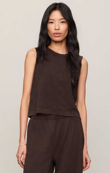 Woman wearing a dark chocolate brown Sloane sleeveless top and pants against a neutral background