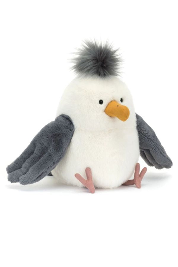 A plush chip seagull toy with a white body, dark gray wings, a yellow-orange beak, and a black tuft of hair on top, sitting against a plain white background.