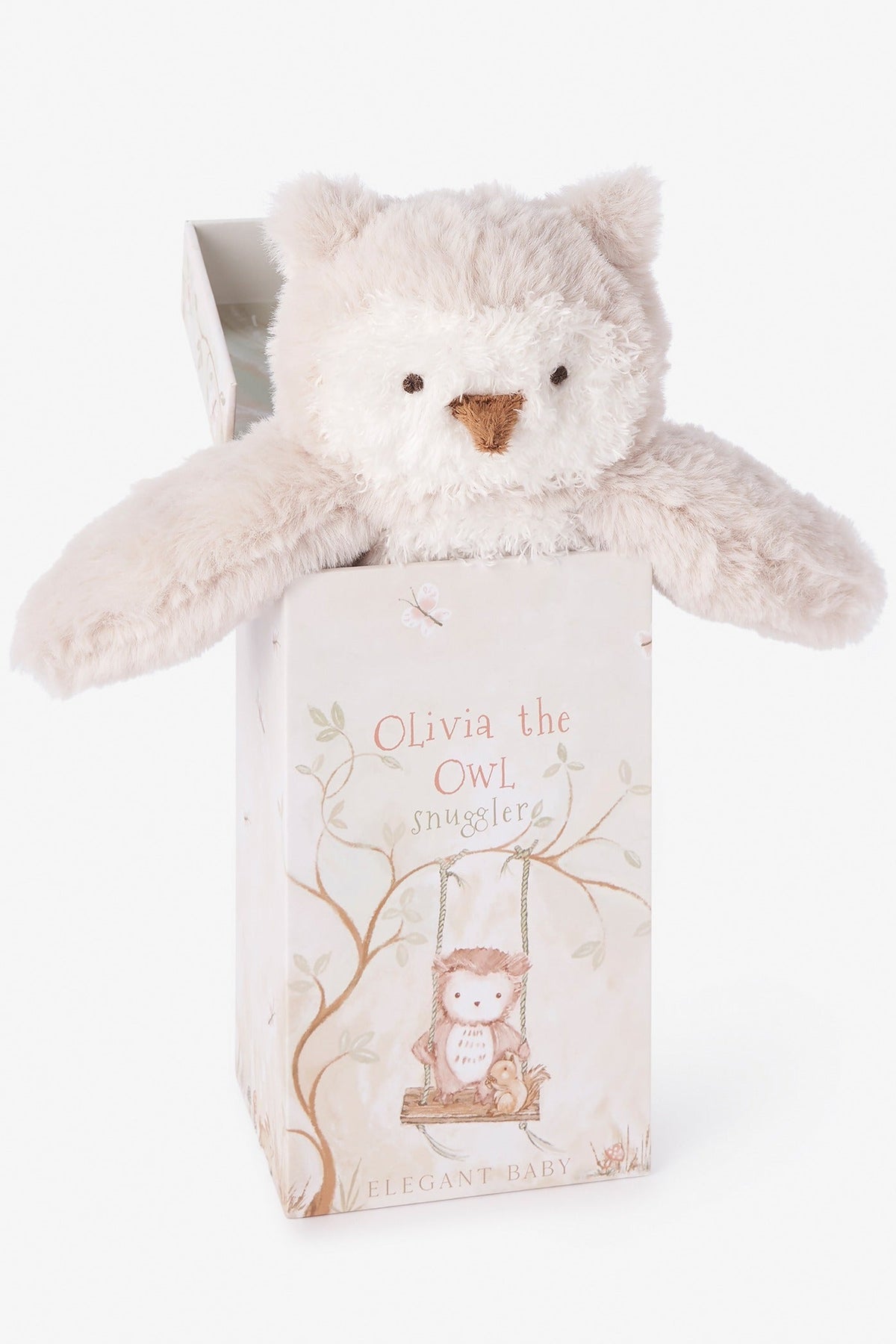 A plush owl named Olivia the Owl made of soft cream-colored plush fabric, emerging from its illustrated gift box. The box features a whimsical illustration of the owl on a swing and the text 'Olivia the OWL SNUGGLER' and 'ELEGANT BABY'.