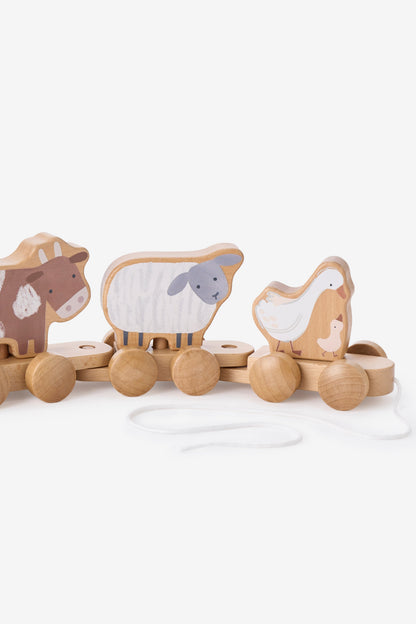 Wooden toy train with cow, sheep, and duck figures on a white background