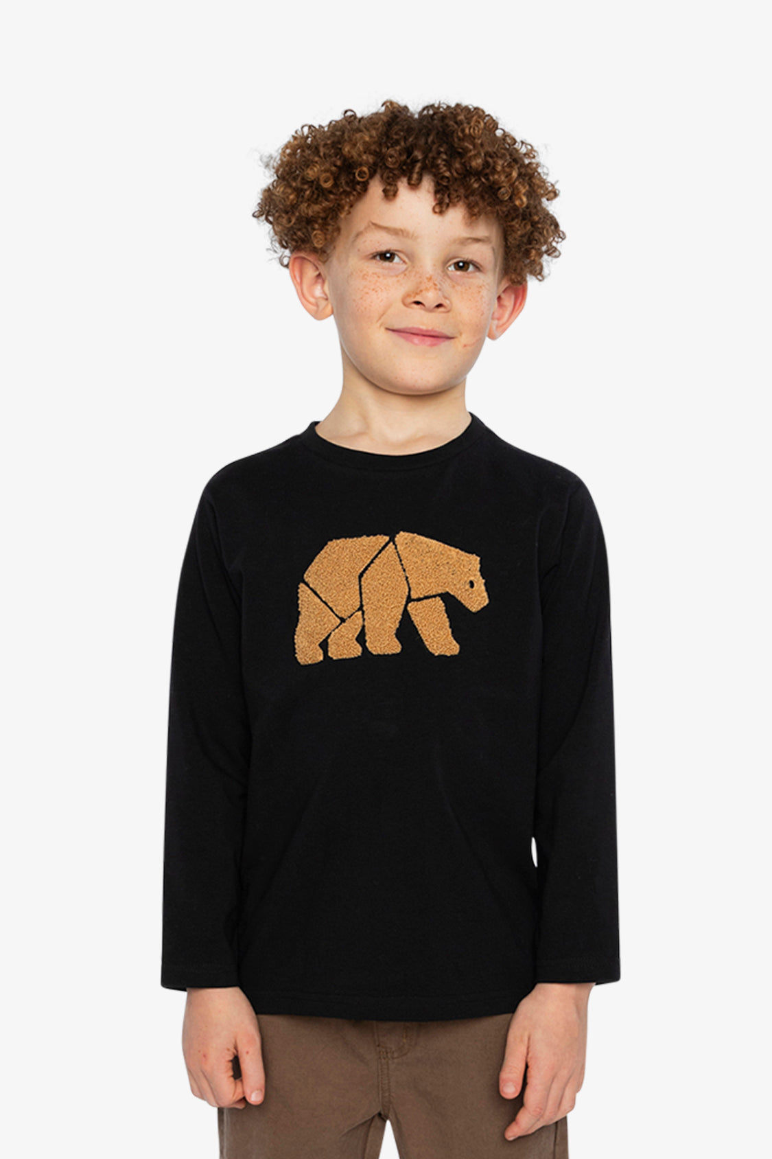 Child wearing a black long-sleeve shirt with a bear graphic on a white background