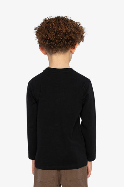 Child wearing a black long-sleeve shirt on a white background