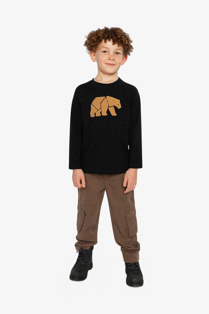 Child wearing a black long-sleeve shirt with a bear graphic and brown pants on a white background