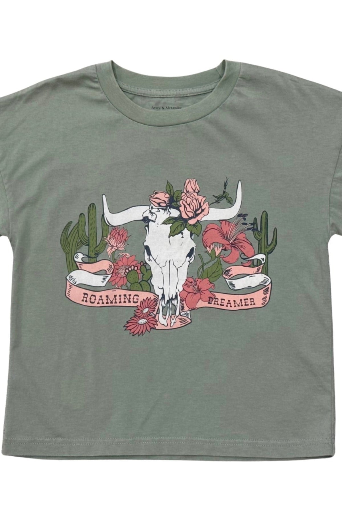 Detailed View: A sage green short-sleeve t-shirt with a central graphic of a white longhorn skull decorated with pink flowers, surrounded by cacti and a banner that reads 'ROAMING DREAMER'.