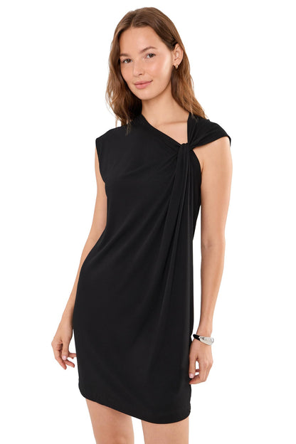 A woman modeling a sleeveless black mini dress with a twisted knot detail at the neckline, photographed against a plain white background.