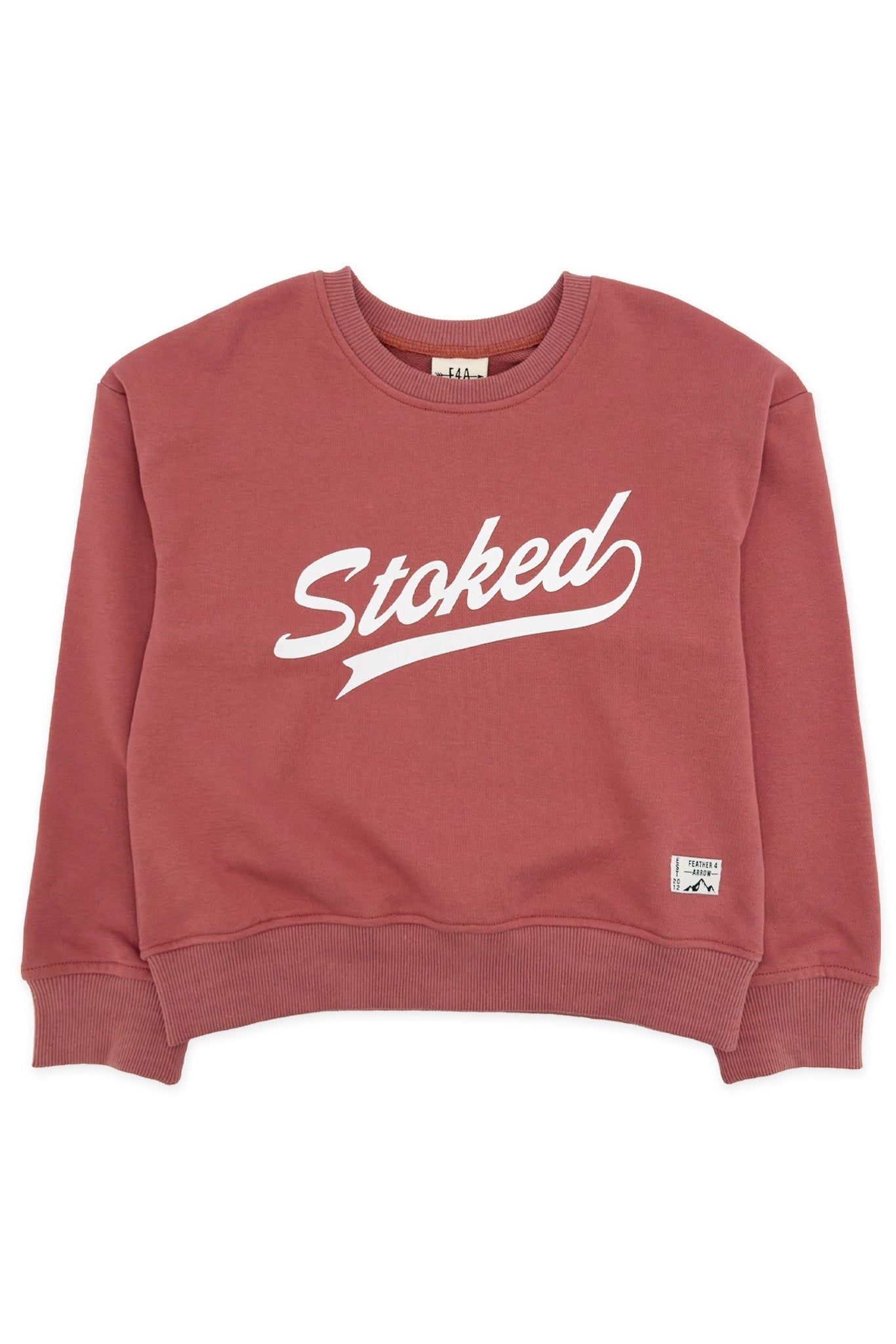A dusty rose crewneck sweatshirt with 'Stoked' printed in white script across the chest and a small white logo patch near the lower right hem, shown on a plain white background.
