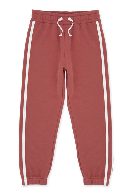 A pair of dusty canyon red sweatpants with white side stripes and a white drawstring, shown flat against a white background.