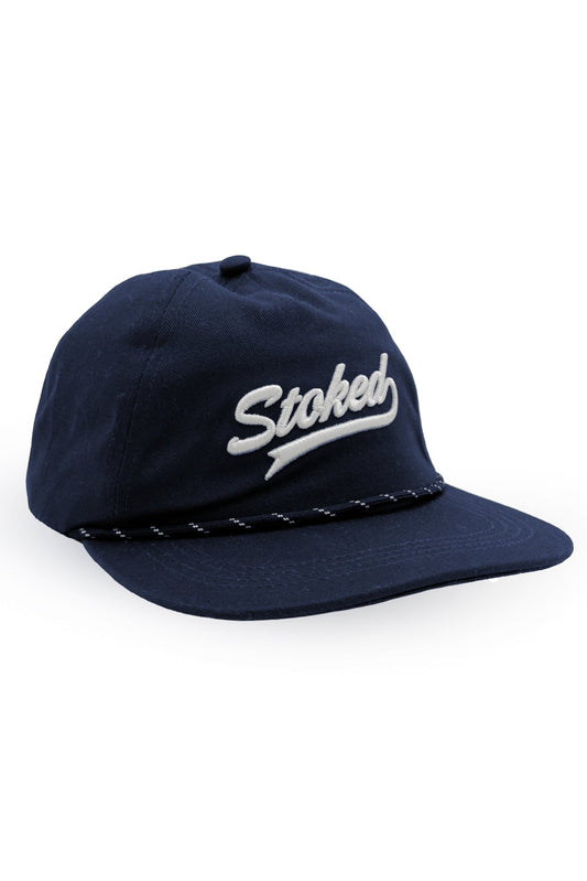 A navy blue baseball cap with 'Stoked' embroidered in white script on the front, featuring a braided rope detail around the edge of the brim, set against a plain white background.