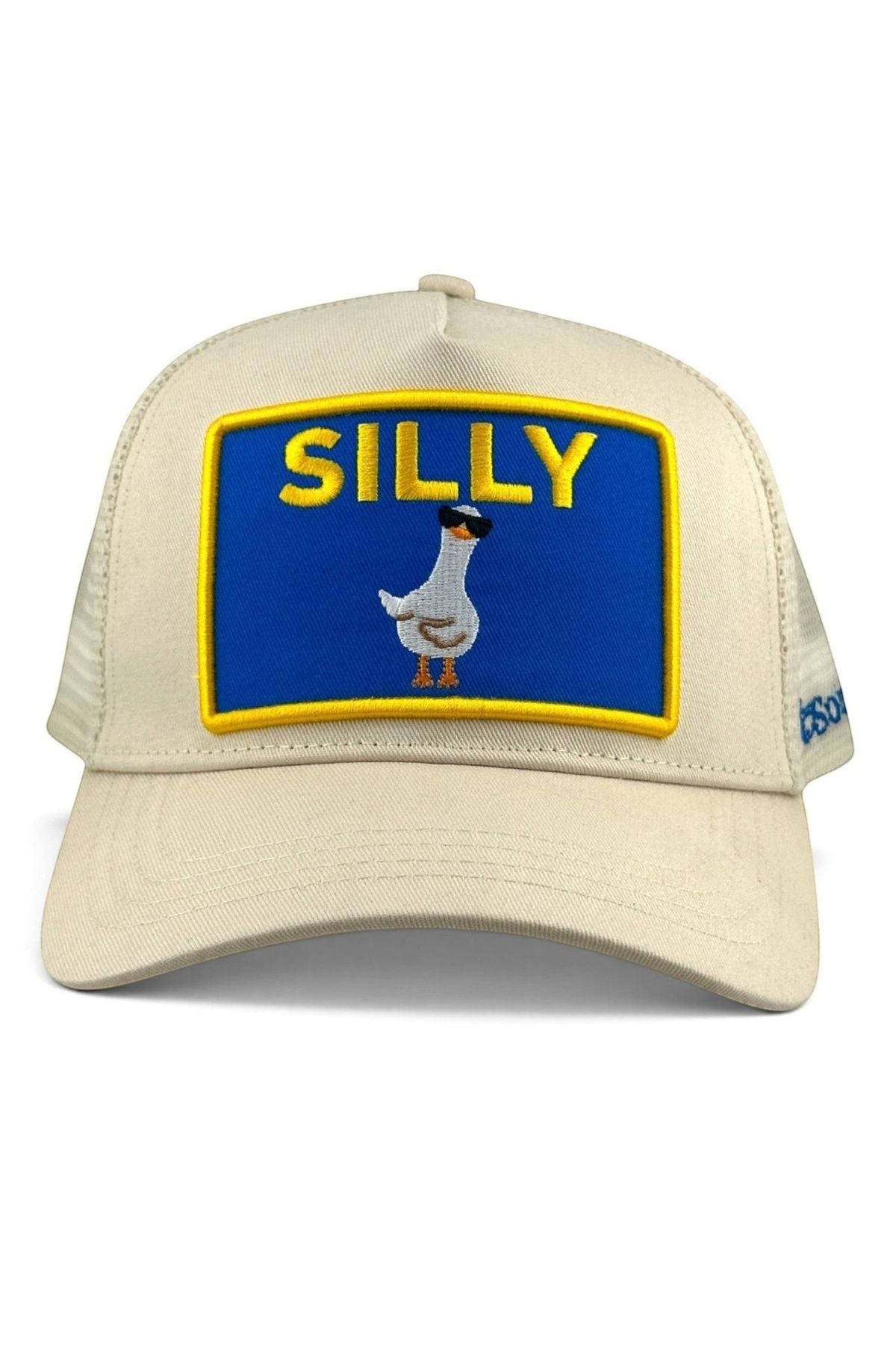 A beige trucker-style cap with a large rectangular front patch featuring a blue background, yellow border, the word 'SILLY' in yellow, and a cartoon goose wearing sunglasses. The side of the cap shows a small blue 'DS' logo.