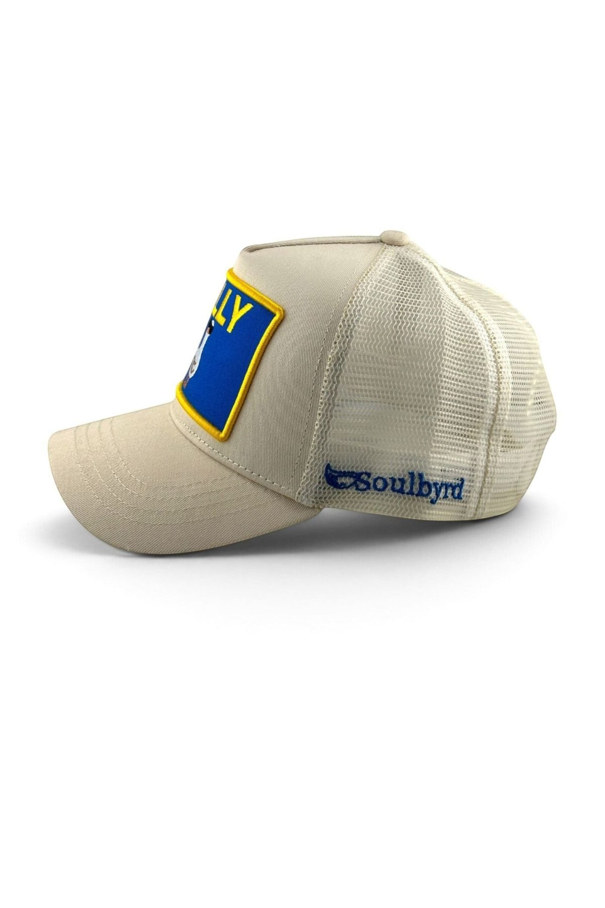A beige trucker-style cap with a blue and yellow patch on the front and a blue Soulbyrd logo on the side, shown against a plain white background.