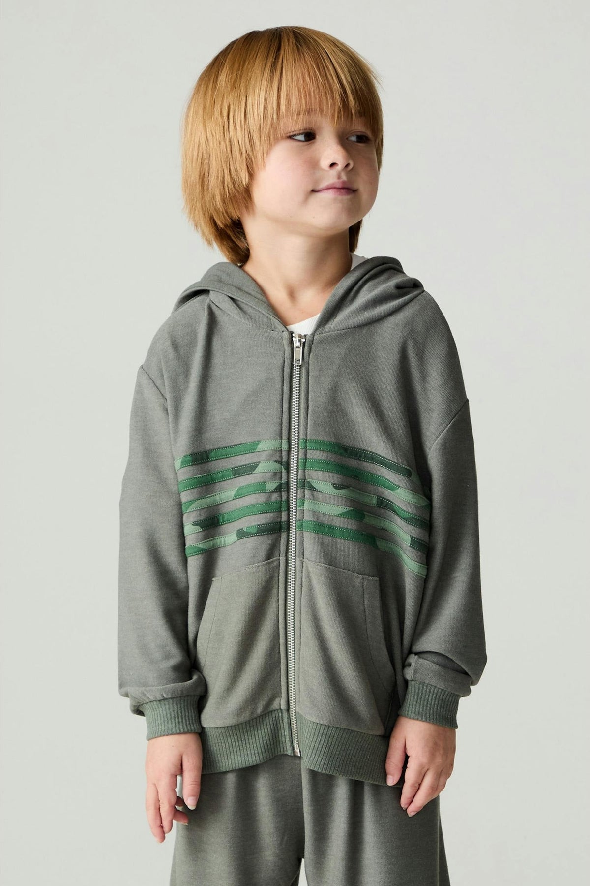 Boy wearing a safari cool camo print stripe hoodie with matching pants 