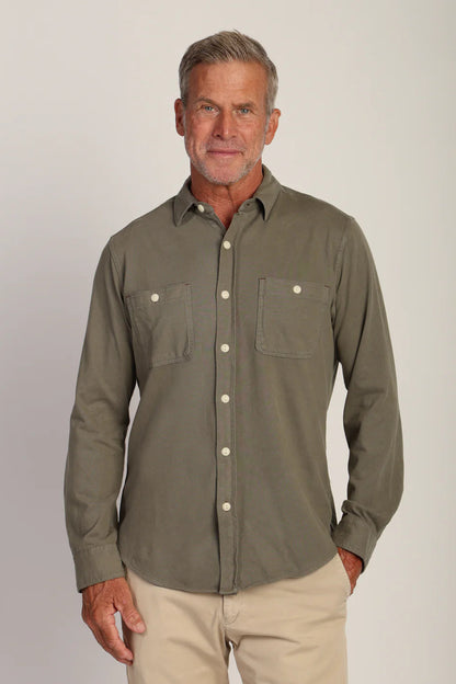 Man wearing long sleeve button down shirt with double pockets in agave color 