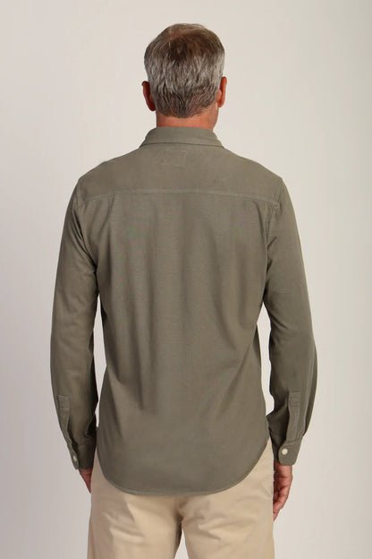 Back view an wearing long sleeve button down shirt in agave color 