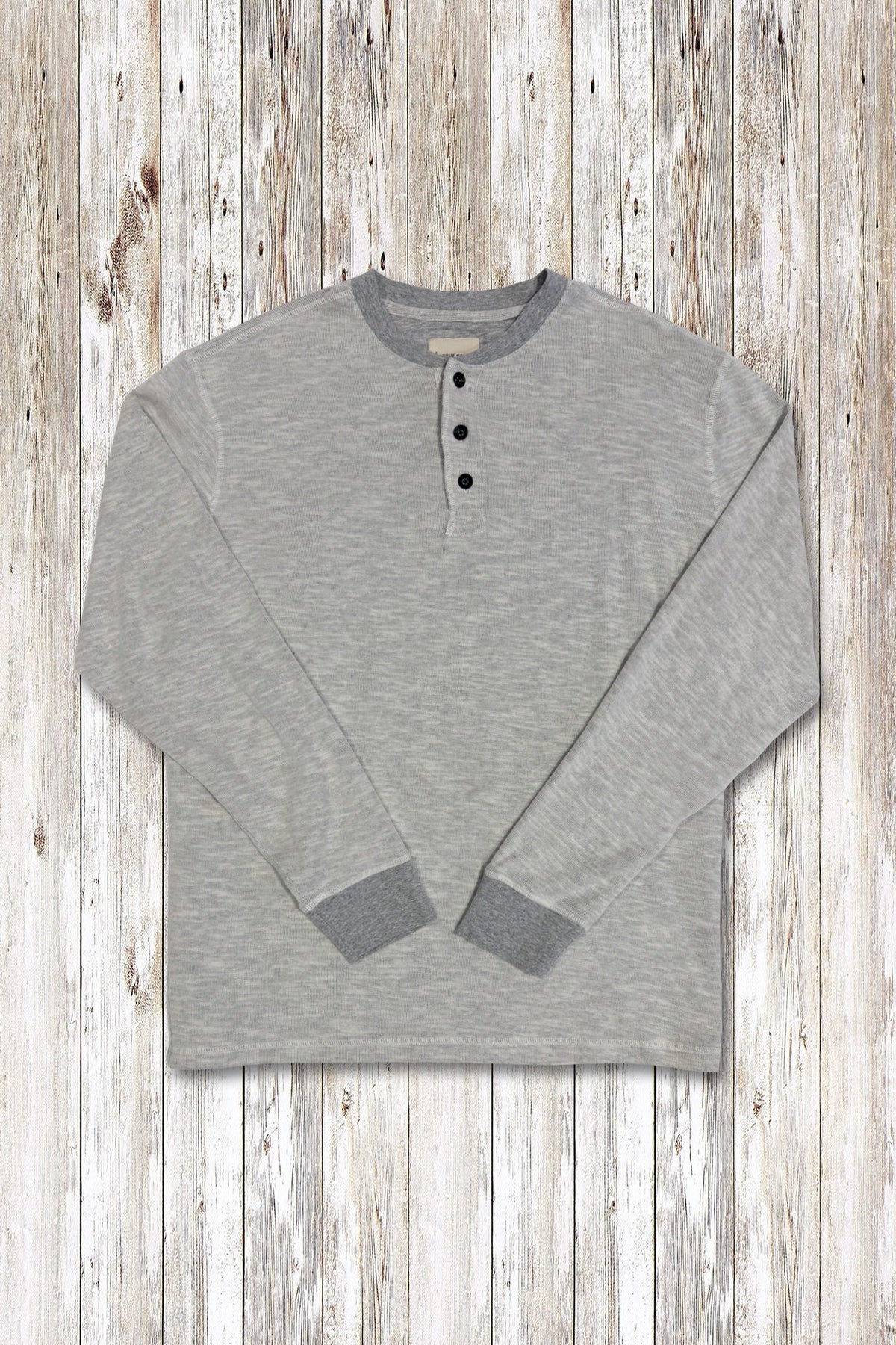 Heather grey long-sleeve rib henley shirt on a wooden surface