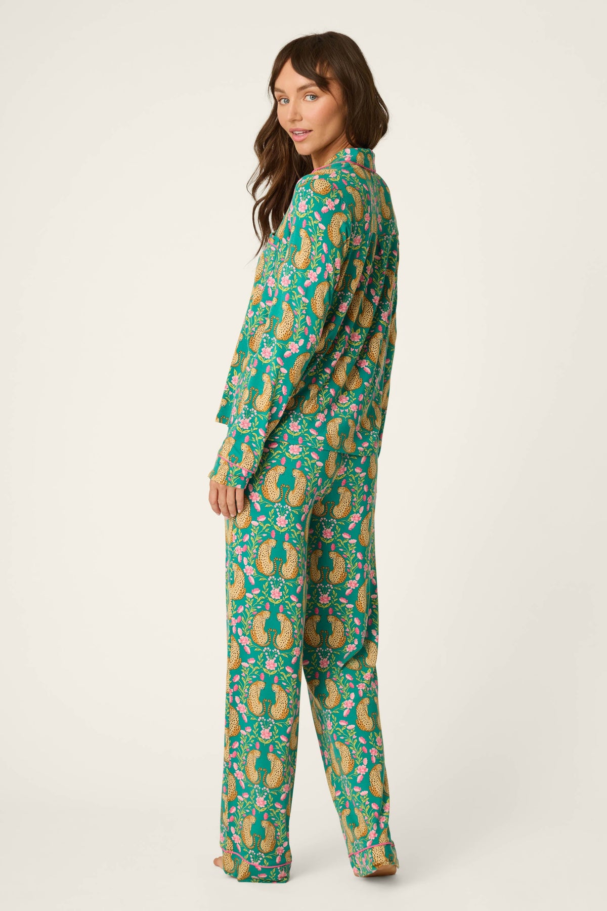 Woman shown from the back wearing a teal blue green long sleeve cheetah pajama set 