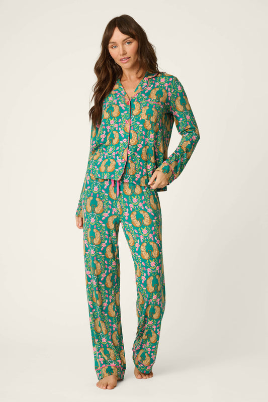 Woman shown from the front wearing a teal blue green cheetah pajama set with pink accents 