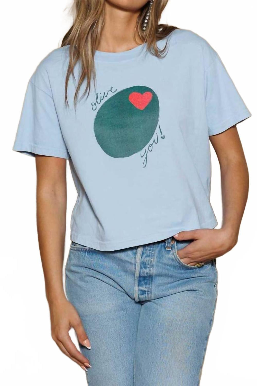 Woman wearing an ice blue Olive You! tshirt with blue jeans 