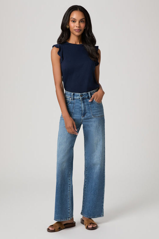 Woman wearing a navy top and Anessa 31" Rounded Stitch blue jeans in monrovia color on a white background