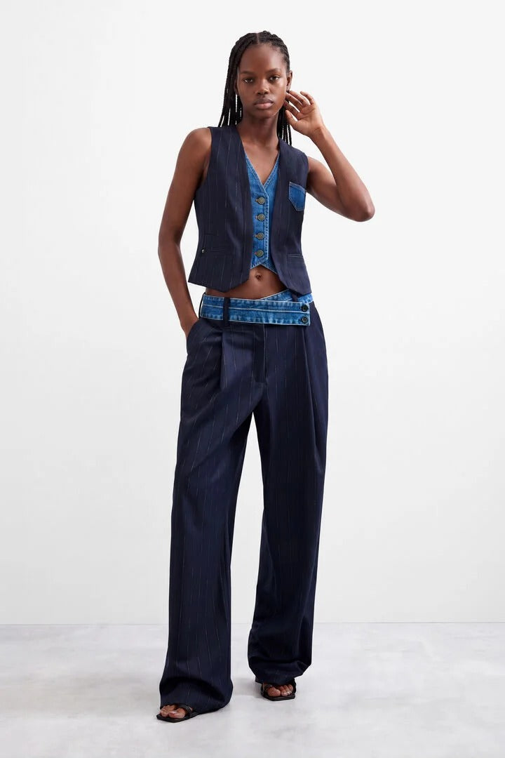 Woman wearing navy azul oscuro double lapel vest with matching navy pants 