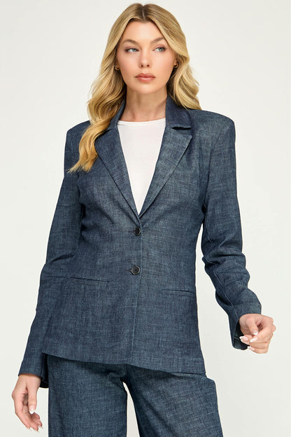 A woman modeling a tailored lennox blazer in stargazer color with matching trousers over a white top, photographed against a plain light background.