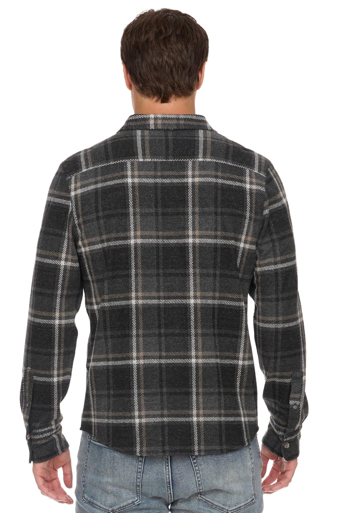 A man viewed from the back wearing a Wadley charcoal gray and black plaid flannel shirt with beige lines, paired with light blue jeans, against a plain white background.