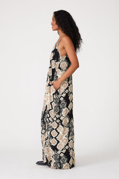 Woman wearing a black & khaki patterned dress on a white background