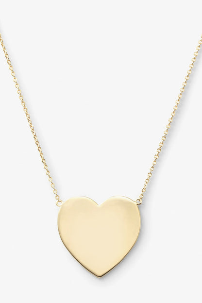 Gold have my heart-shaped pendant on a chain against a white background
